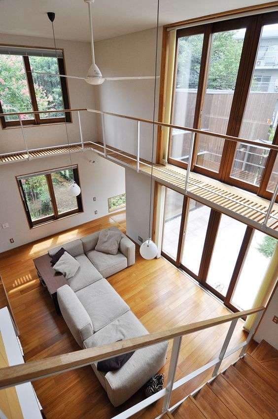An innovative sustainable interior design model that integrates open spaces with natural materials like wood and glass to enhance environmental sustainability.