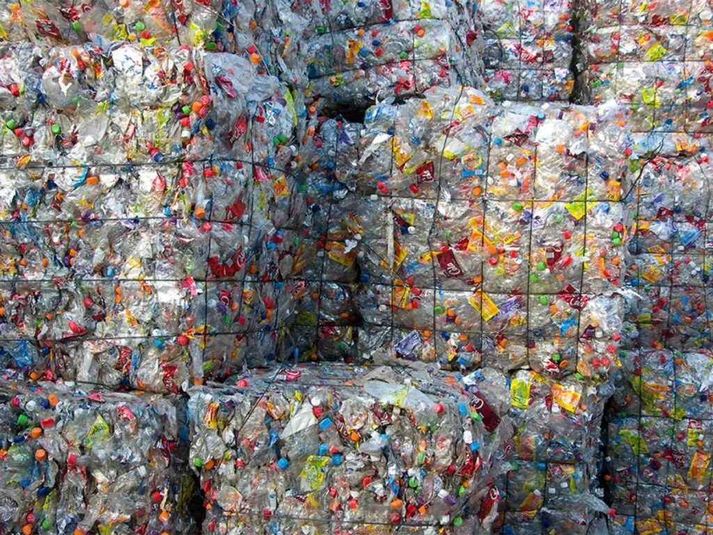 "Compacted plastic bales ready for use as sustainable building materials."