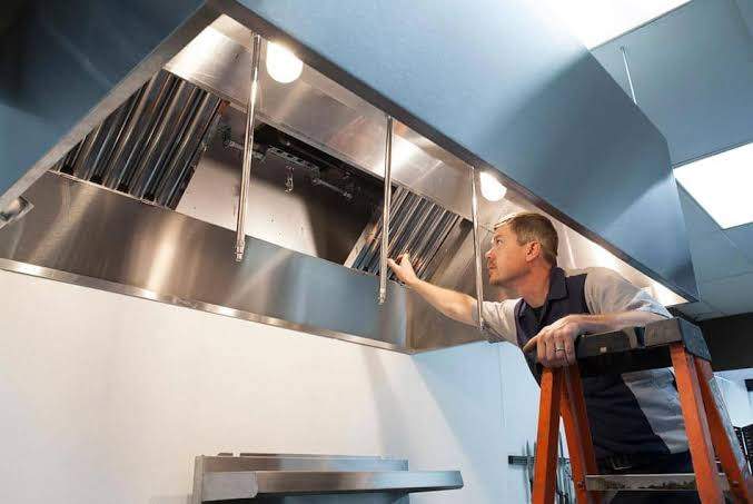 "A worker inspecting roof vents during the installation of an advanced ventilation system."