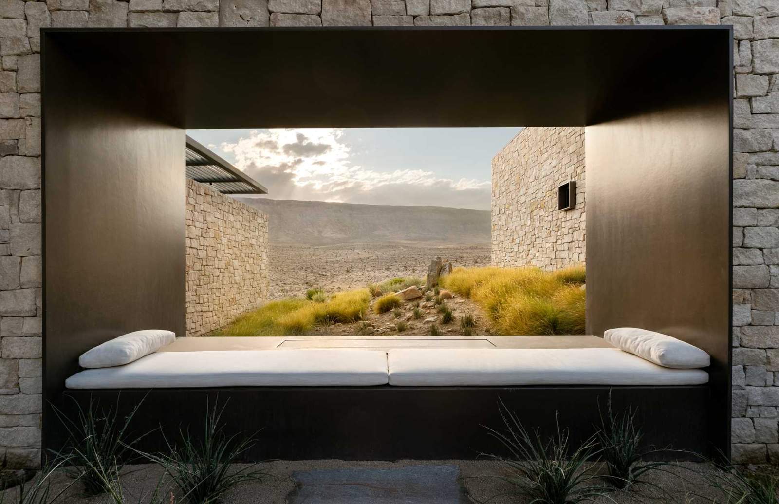 A steel framed day bed has been built into the wall and ideally positioned for the landscape views.