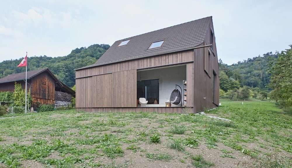 Residential barn featuring an unfinished interior in the Swiss rural landscape