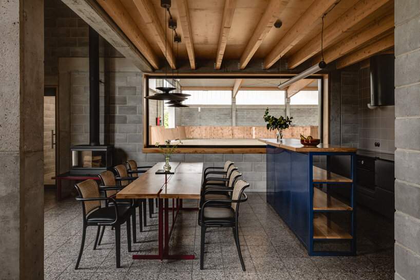 raw concrete, steel panels, and wood wrap wiercinski studio's equestrian center in poland
