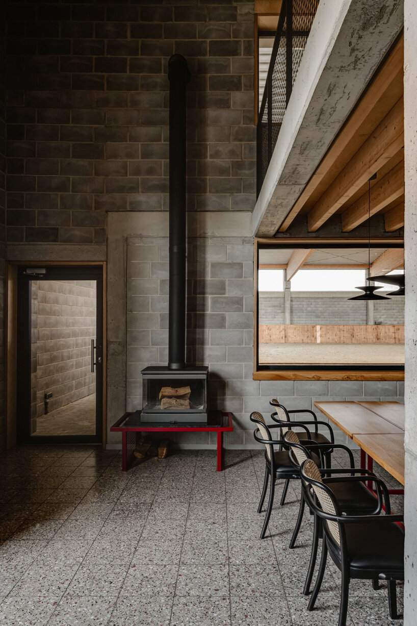 raw concrete, steel panels, and wood wrap wiercinski studio's equestrian center in poland