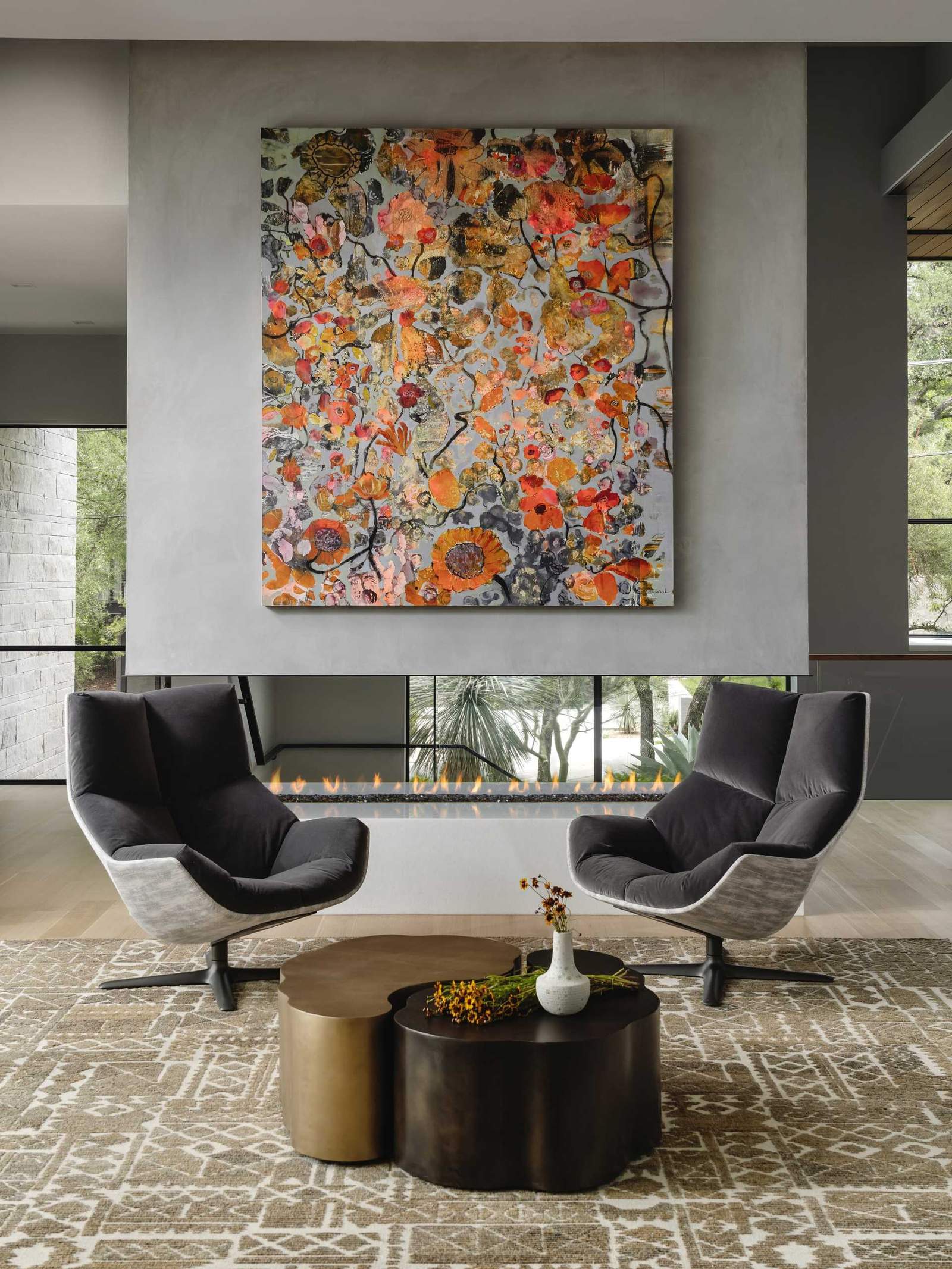 A modern fireplace with a large colorful artwork above.