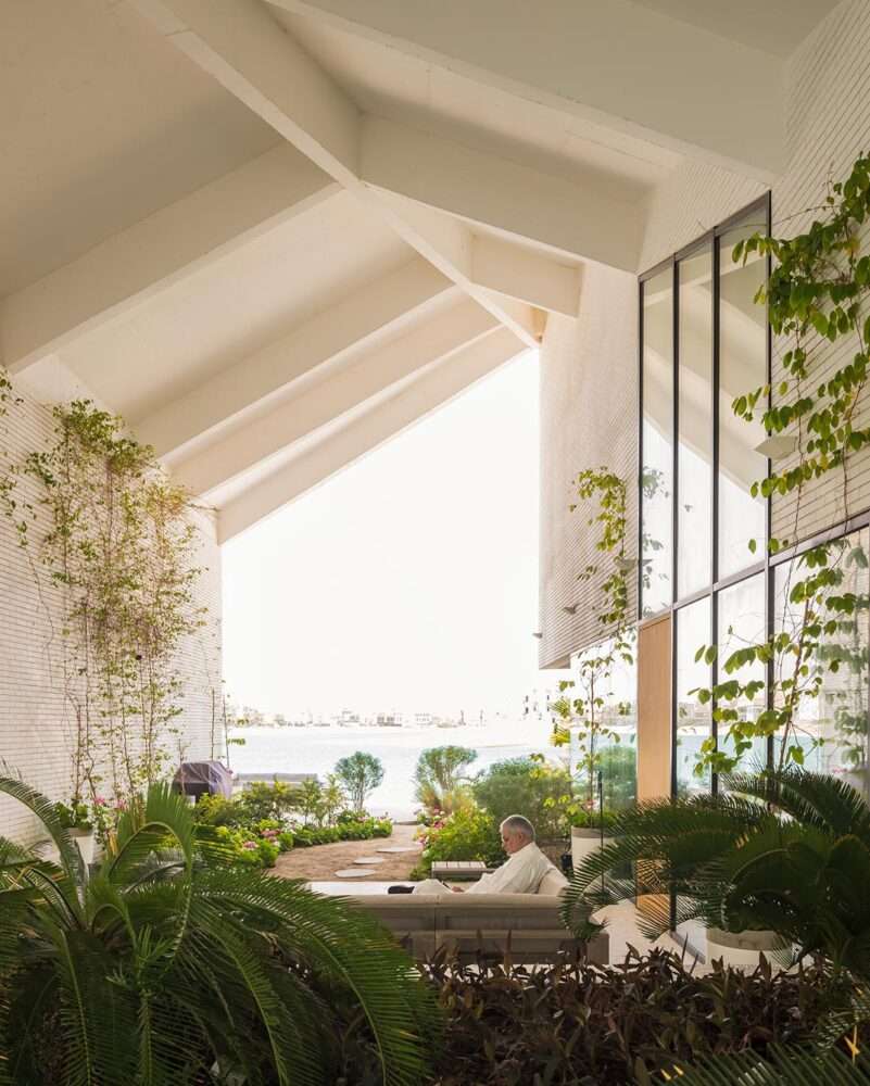 Covering a family home with a folded roof to create a tent-like structure in Kuwait