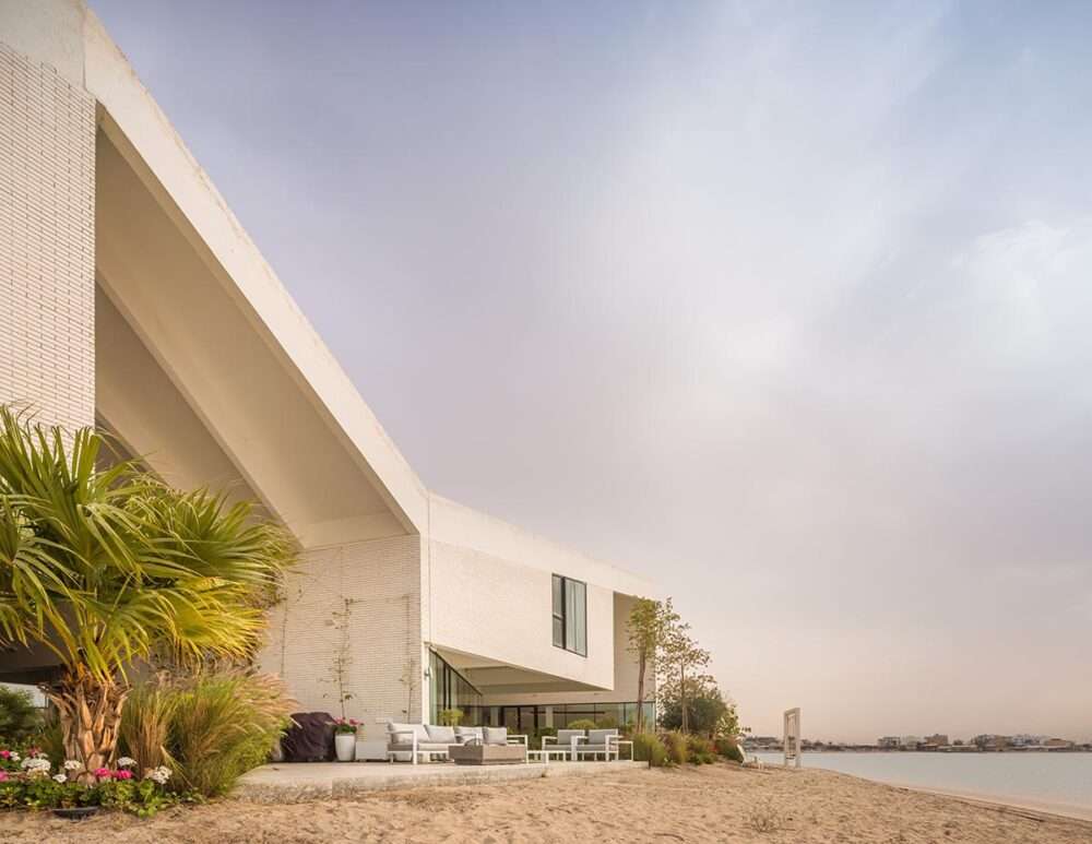 Covering a family home with a folded roof to create a tent-like structure in Kuwait