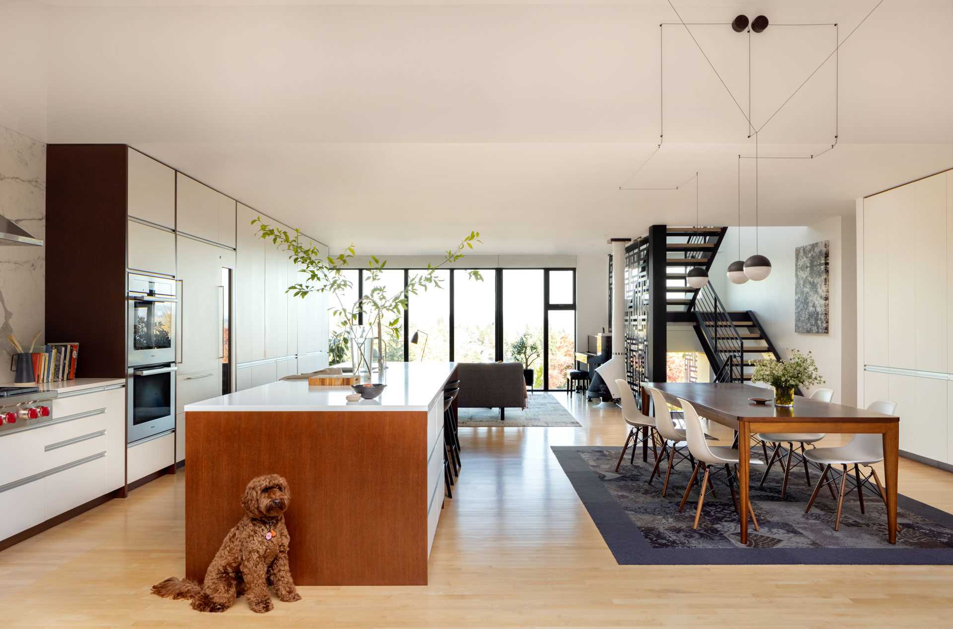 To enhance the aesthetics and functionality of this remodeled home, the original closed stairway was replaced with a steel and wood open riser stairwell.