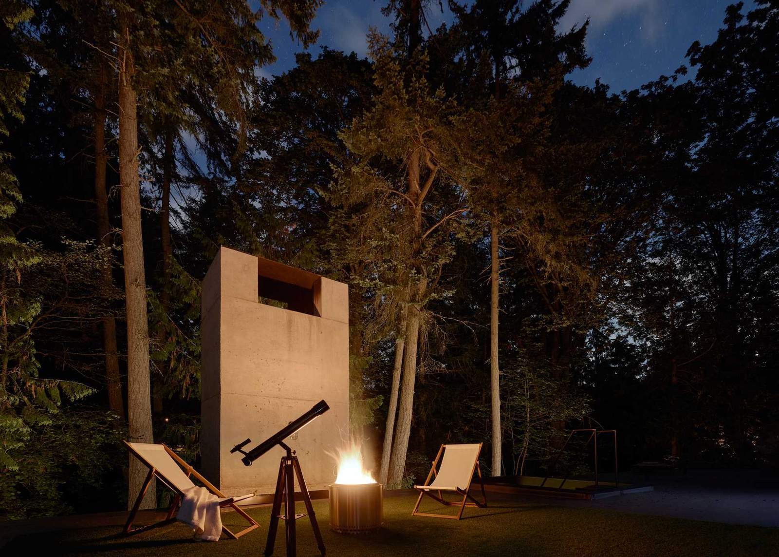 This modern home has a rooftop that's set up for star gazing and an elevated herb garden that's accessible via steel stairs.