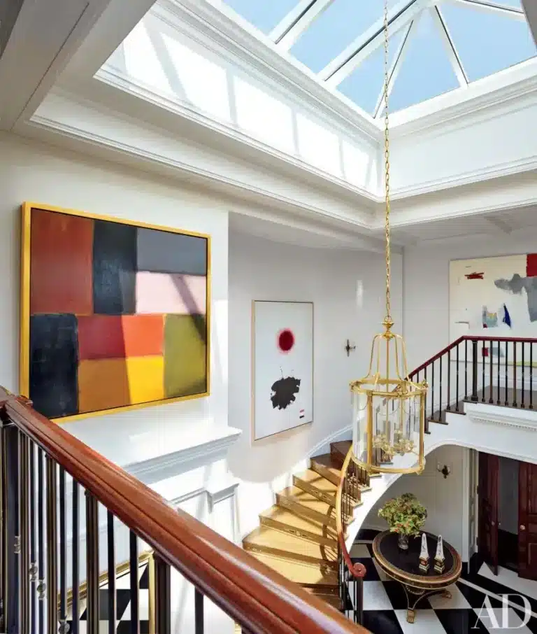 "Modern staircase design with a glass skylight illuminating the room naturally."