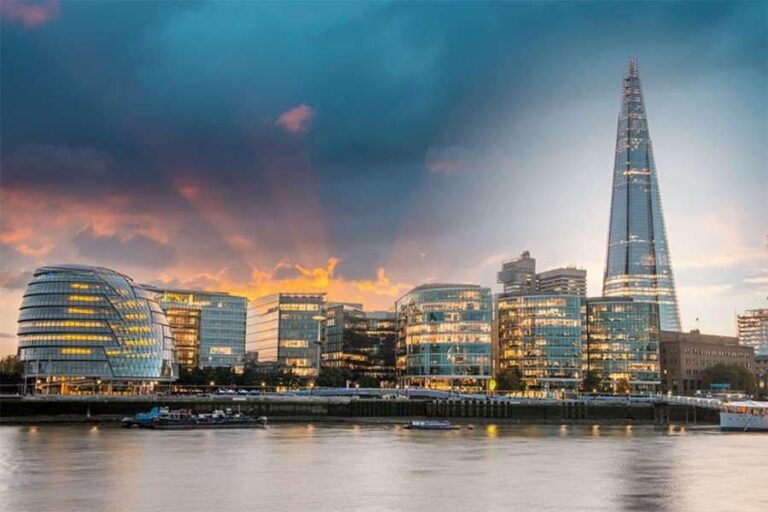 "The Shard in London, illuminated with its distinctive glass lights, stands as the tallest building in the city