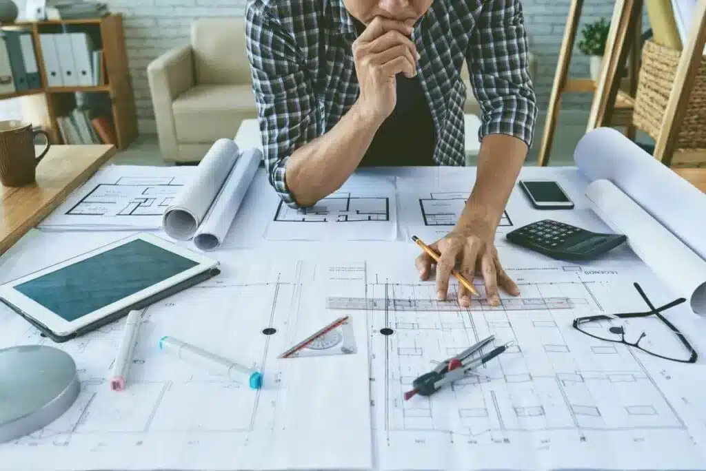 Architect analyzing blueprints: Difficulty Studying Architecture