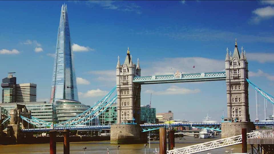 "The Shard illuminated in the background, with Tower Bridge standing as a historic landmark in the foreground