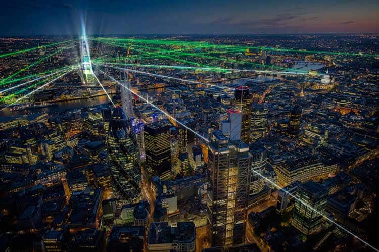 "Aerial view of London at night from The Shard, with laser beams illuminating the cityscape