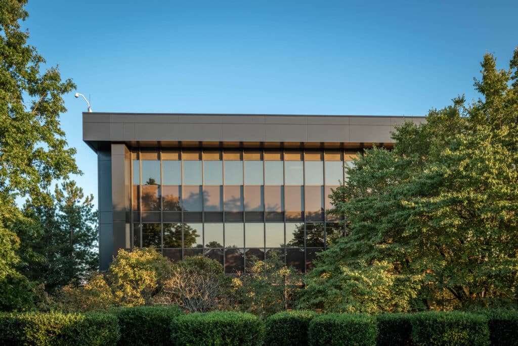 Modern building with futuristic glass design, showcasing the impact of advanced technology on architecture.
