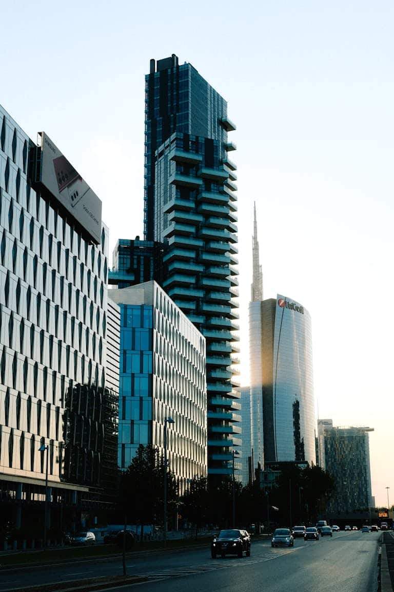 A stunning cityscape featuring sleek skyscrapers and a tranquil street view during sunset.