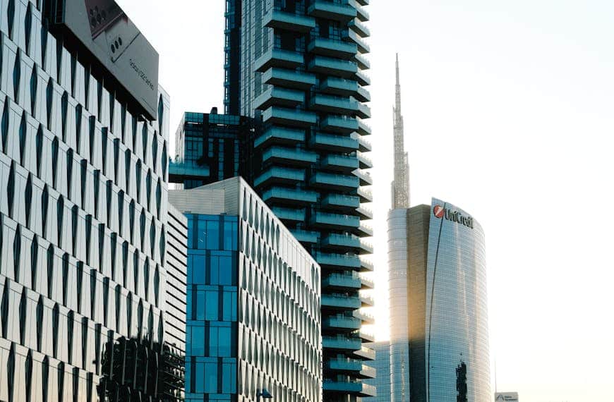 A stunning cityscape featuring sleek skyscrapers and a tranquil street view during sunset.