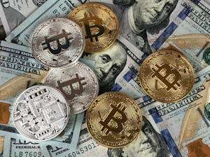 Close-up of bitcoins and US dollar bills symbolizing modern finance and cryptocurrency.