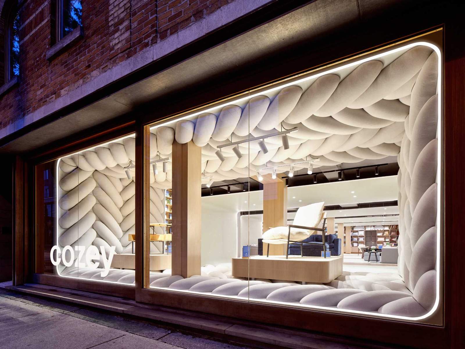 The design of this retail window showcase displays a giant fabric weave to draw pedestrians inside the space.