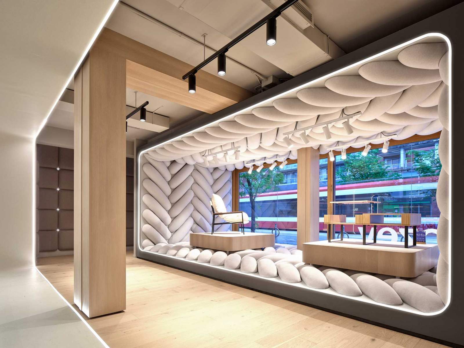 The design of this retail window showcase displays a giant fabric weave to draw pedestrians inside the space.