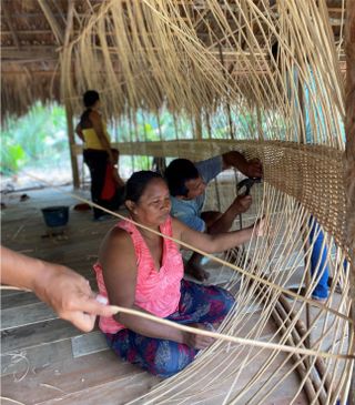 people weaving walls