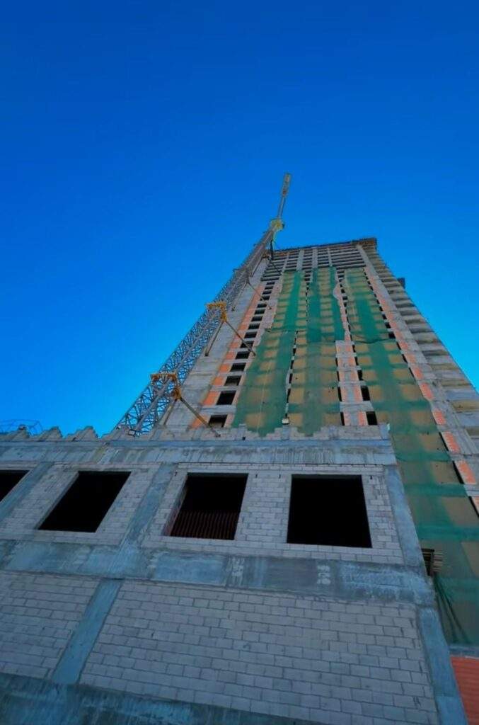 "Tuwaiq Heritage Tower under construction, showing the main structure and cranes in the sky."