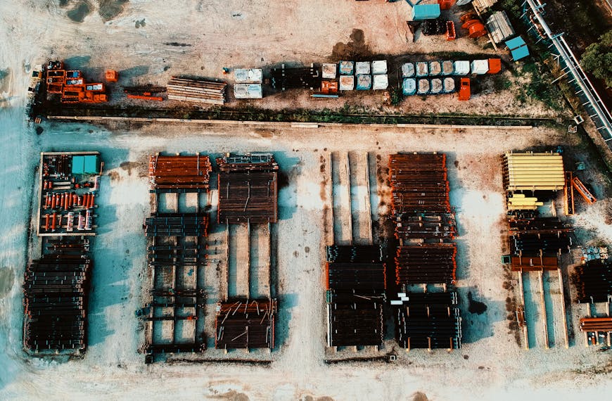 A high angle shot showcasing an industrial yard featuring stacks of steel and metal materials.