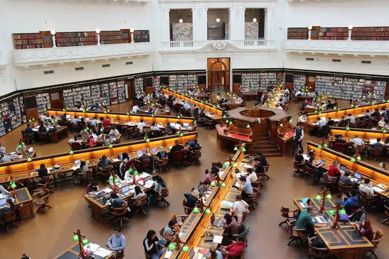 Aerial view of a bustling study hall in a university library with students studying.