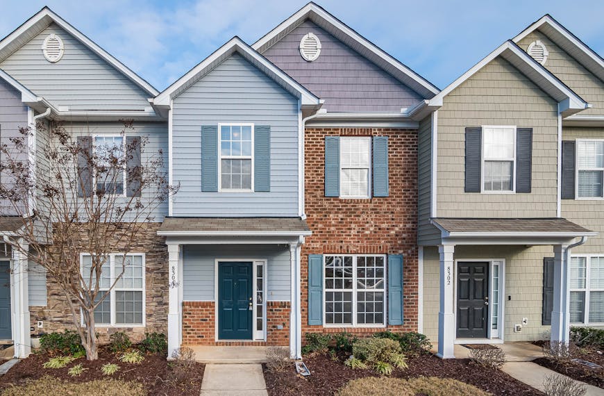 Elegant view of suburban townhouses showcasing diverse architectural styles.