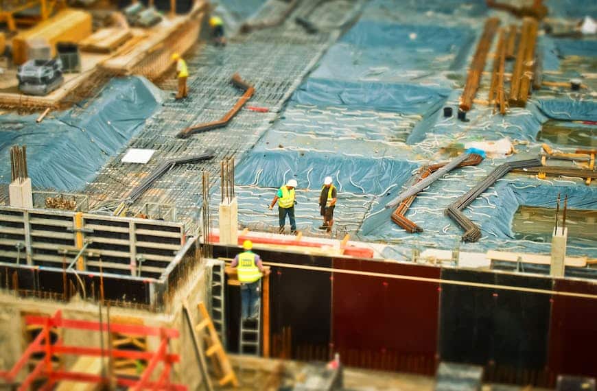 High-angle view of construction workers on a building site, engaging in construction work.
