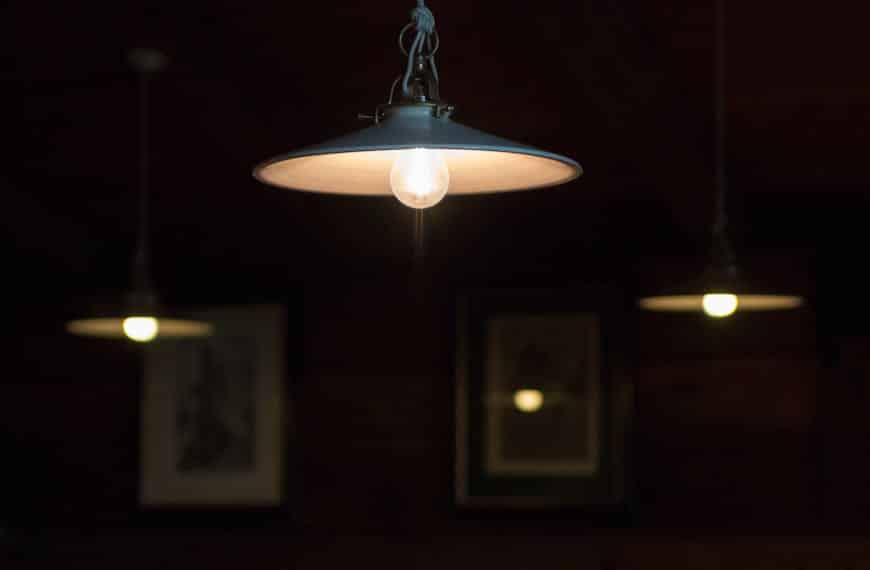 Moody indoor scene featuring hanging pendant lamps dimly lighting a cozy atmosphere.