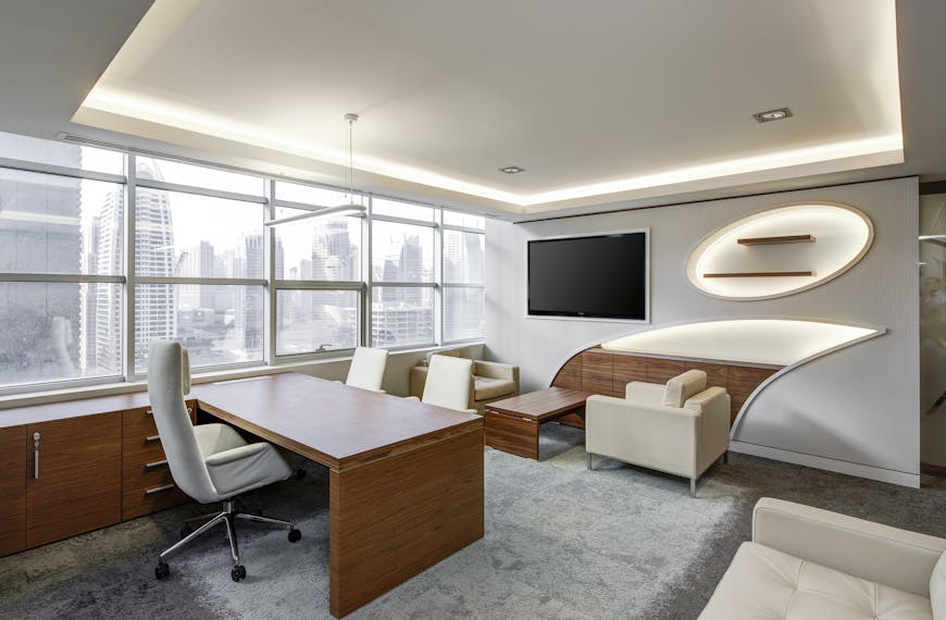 Sleek office space featuring contemporary furniture and city skyline views, ideal for professionals.