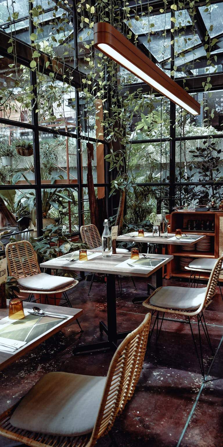 Stylish café in Kuala Lumpur with modern decor and abundant greenery.