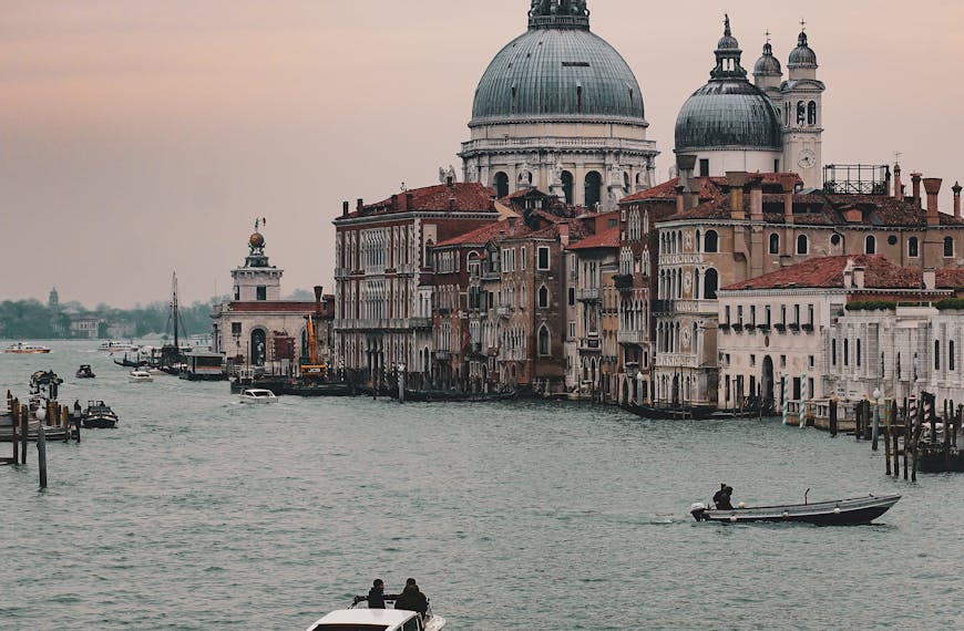 Beautiful view of Venice's Grand Canal featuring the iconic Basilica di Santa Maria della Salute and boats.