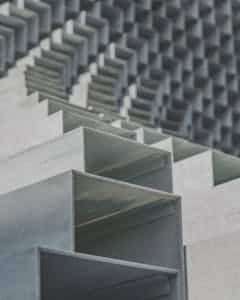 Close-up of abstract geometric metal structures with a minimalist and urban vibe.