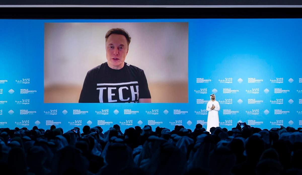 Elon Musk speaking via video call at the World Governments Summit in Dubai alongside Omar Sultan Al Olama, discussing the Dubai Loop transportation project.