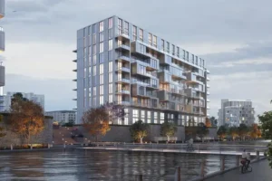 A modern waterfront residential building at dusk.