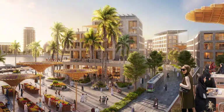 A panoramic view of the New City Salalah development showcasing residential buildings green spaces and a waterfront marina under a clear sky