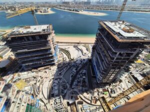 Aerial view of the Serenia Living project on Palm Jumeirah, Dubai, showcasing construction progress with a sea view.