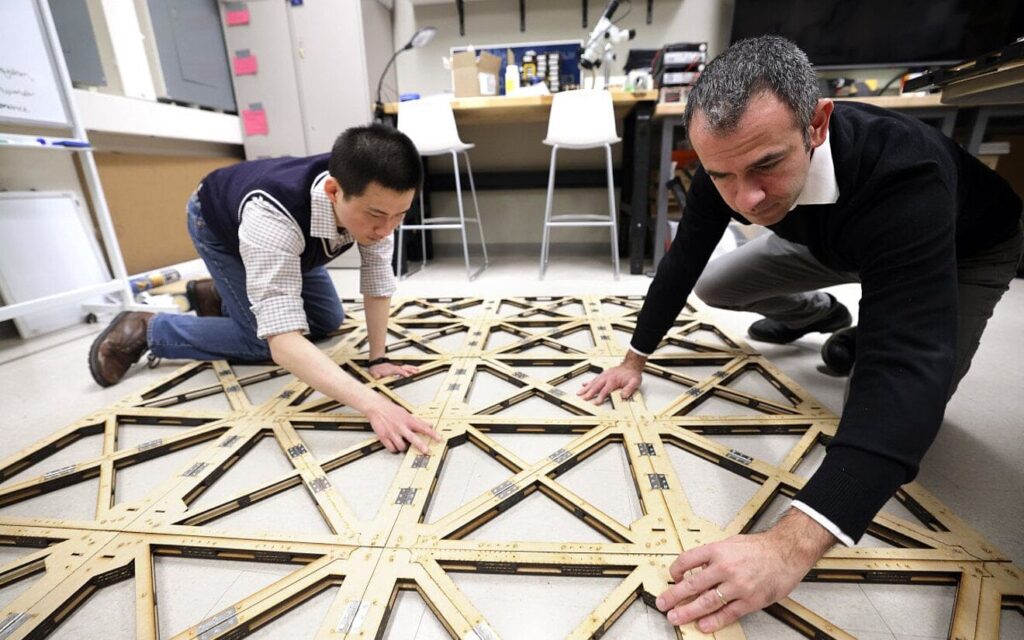 Engineers working on an innovative structural model using wood and metal joints