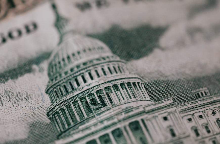 Close-up of the US Capitol illustration on American currency, showing detailed architectural design.
