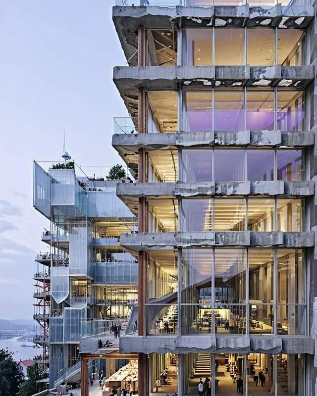 A modern building with an exposed design showing concrete and glass elements