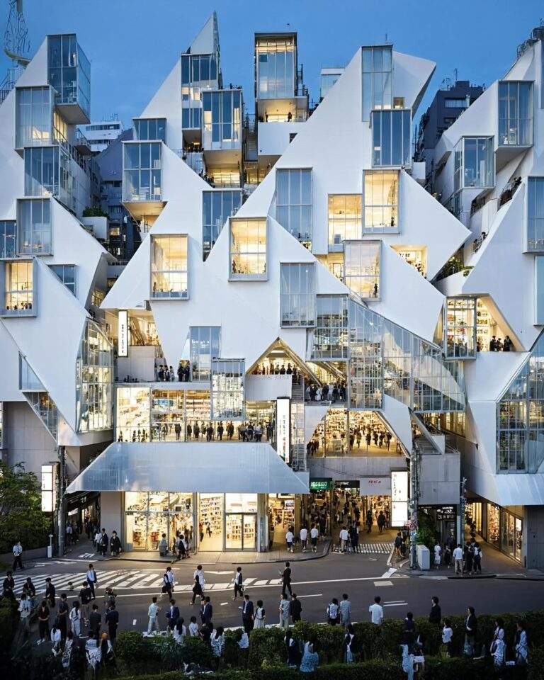 Modern architecture with glass facades and illuminated lights in a multi-story building