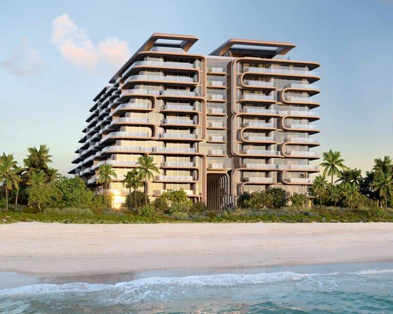 Front view of The Delmore building on Miami beach with palm trees