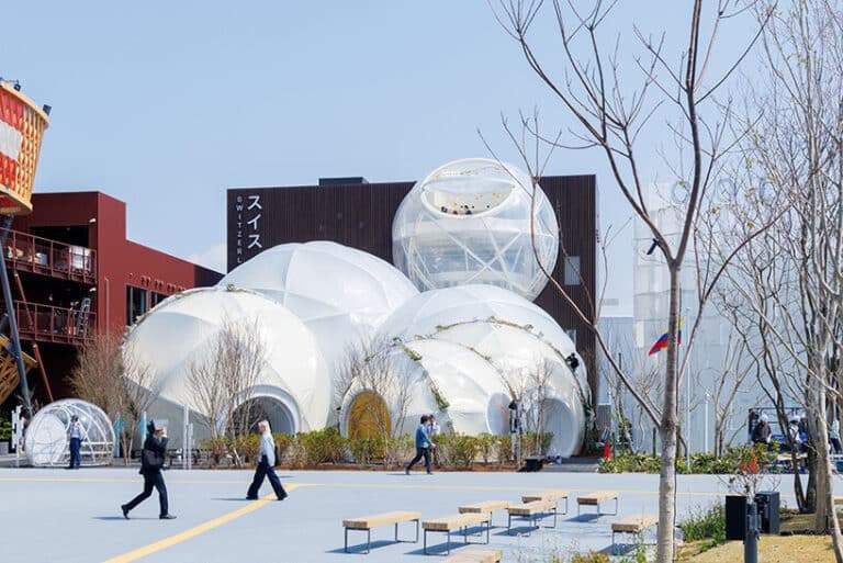 Aerial view of the Swiss Pavilion, showcasing transparent spheres surrounded by flowers.