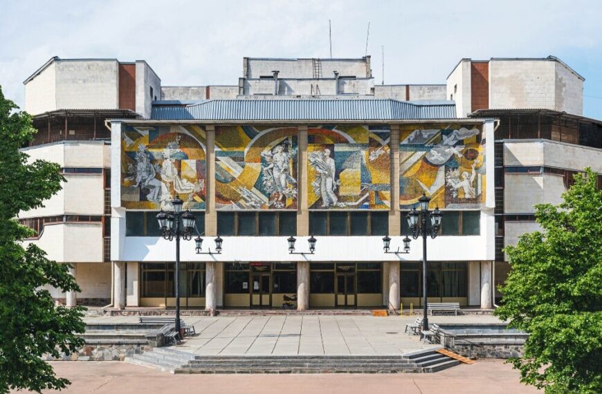 A public building in Ukraine featuring large mosaic art depicting Soviet-era modernist values.