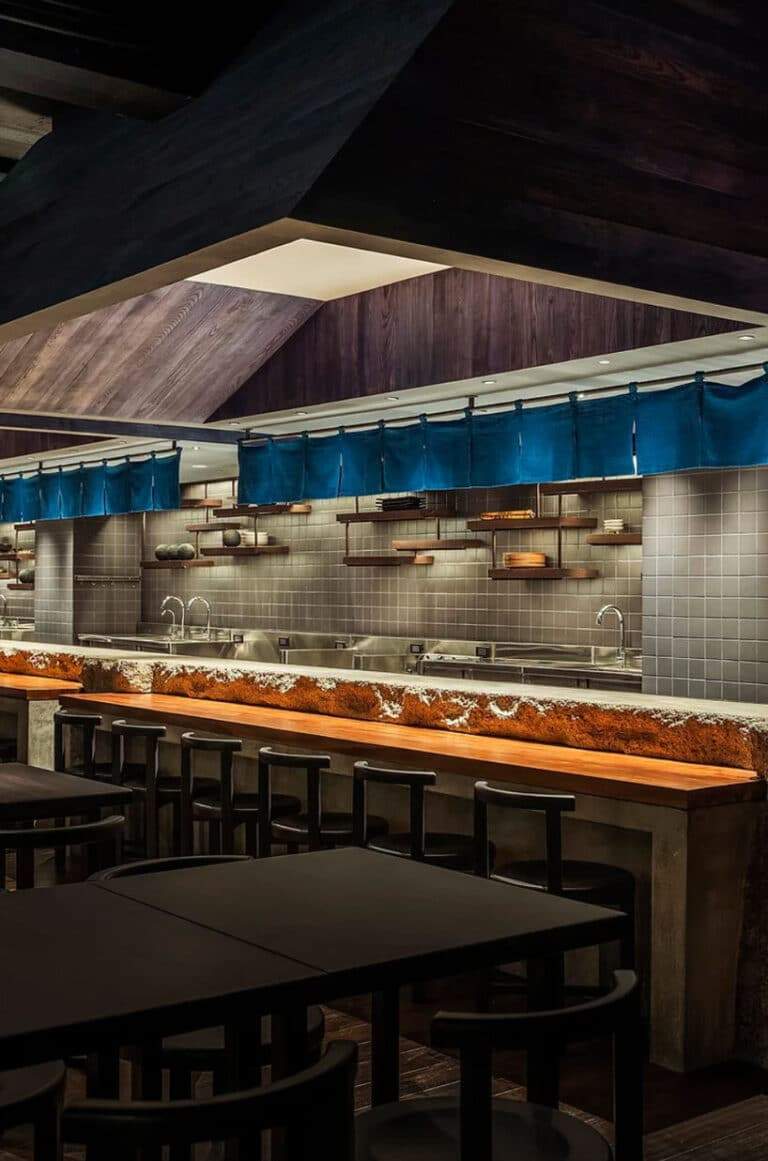"Image showcasing the design of ROKUSHO Izakaya Bar, featuring concrete and indigo fabric to create a cohesive and modern interior."