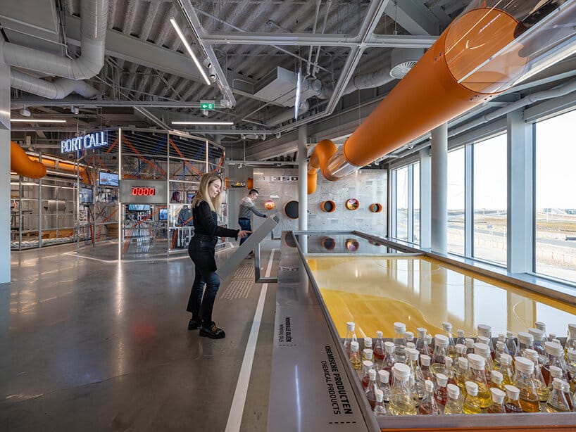 Woman using modern technology to explore port data at the Portlantis Rotterdam exhibition.