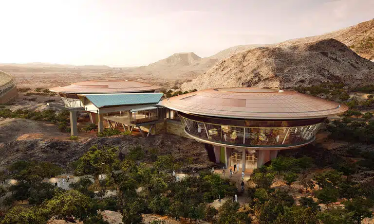 Modern futuristic building in a mountainous desert landscape