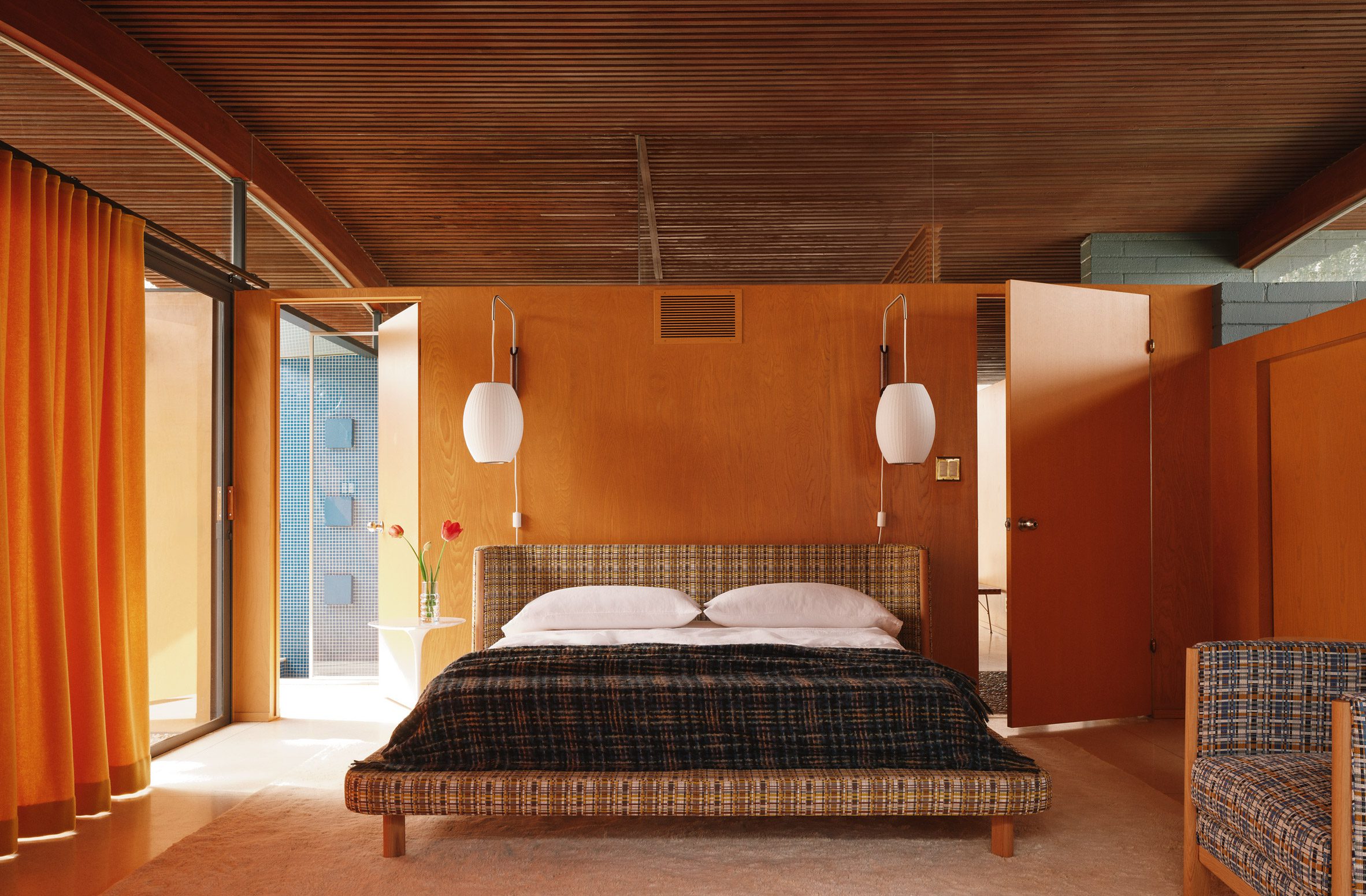 Bedroom with a Covered Bed and Plywood Walls