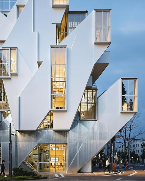 Modern architecture with glass facades and illuminated lights in a multi-story building
